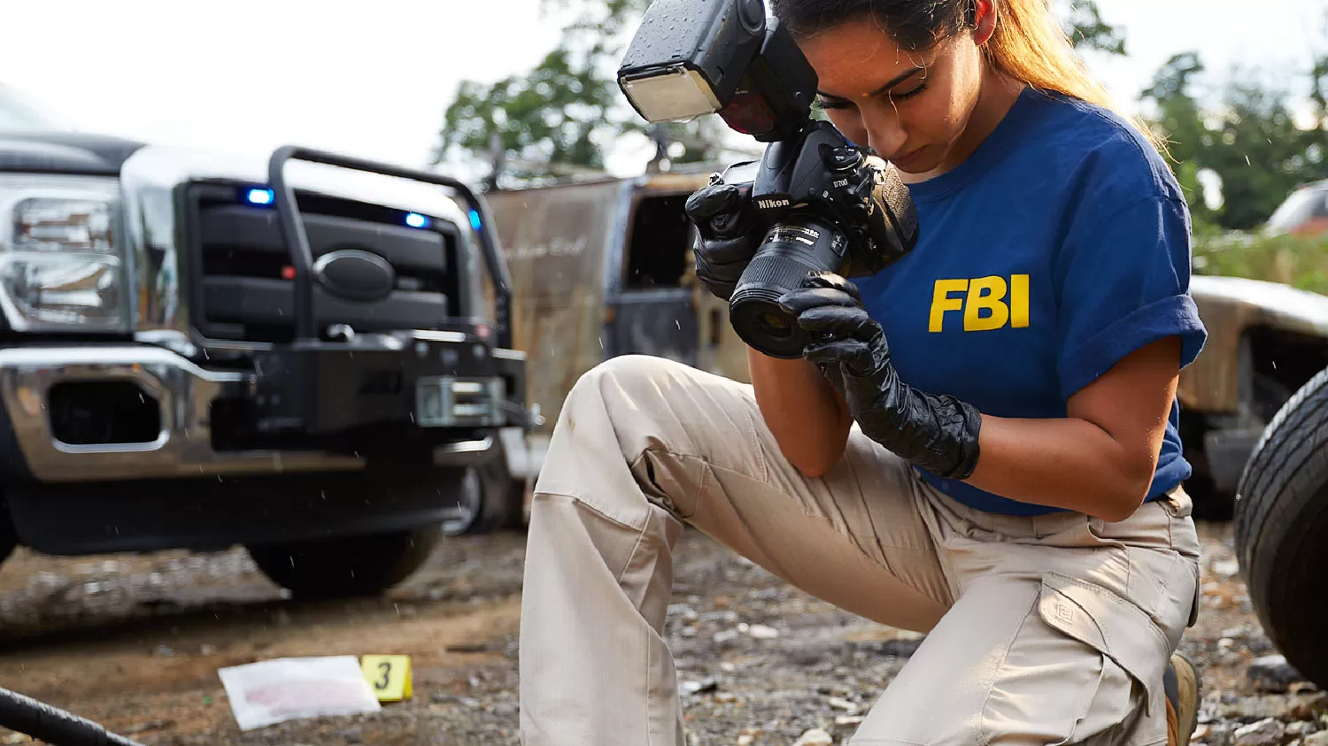 Female FBI employee taking a photo of a crime scene