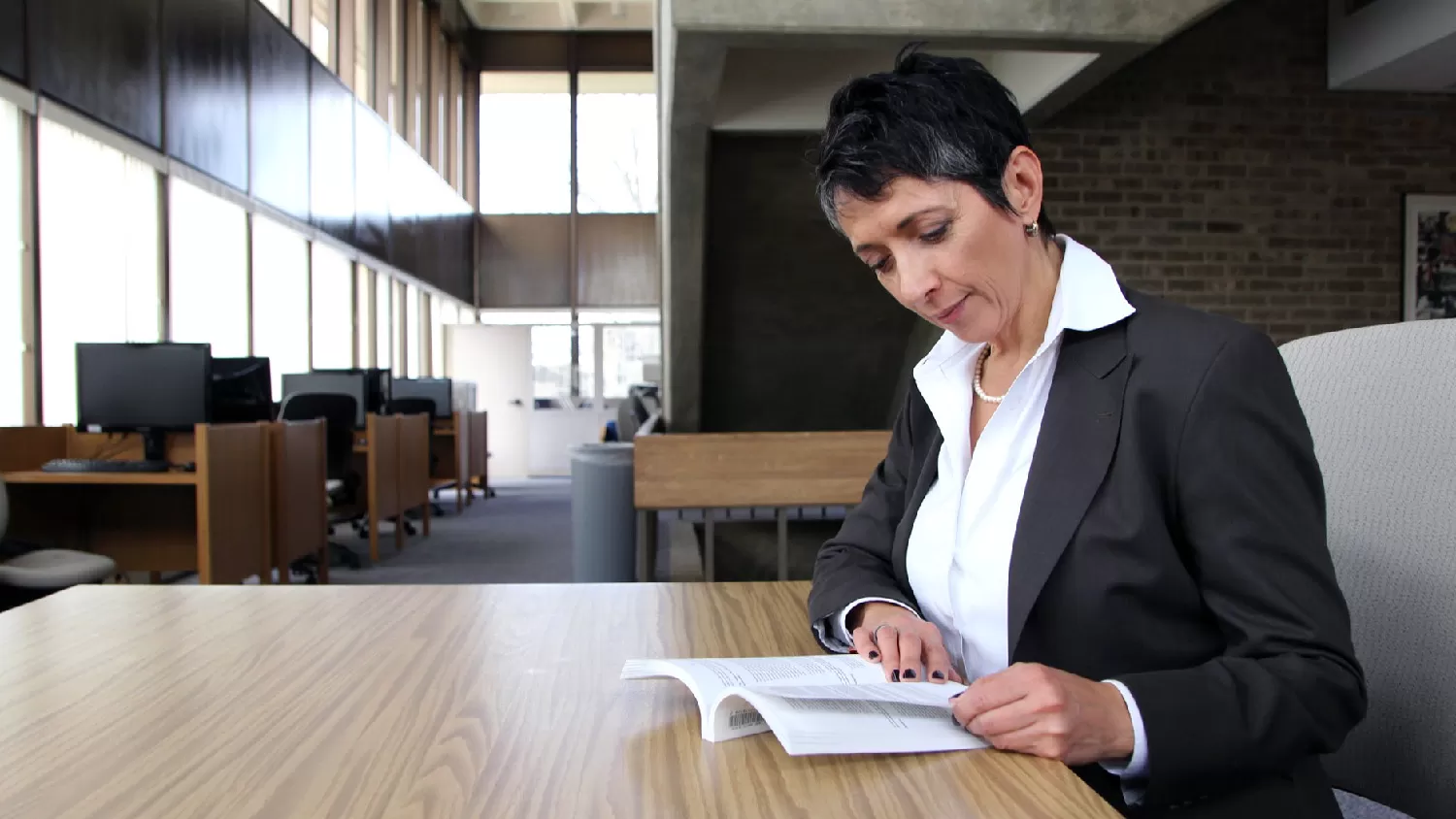 Female in the library studying from booklet