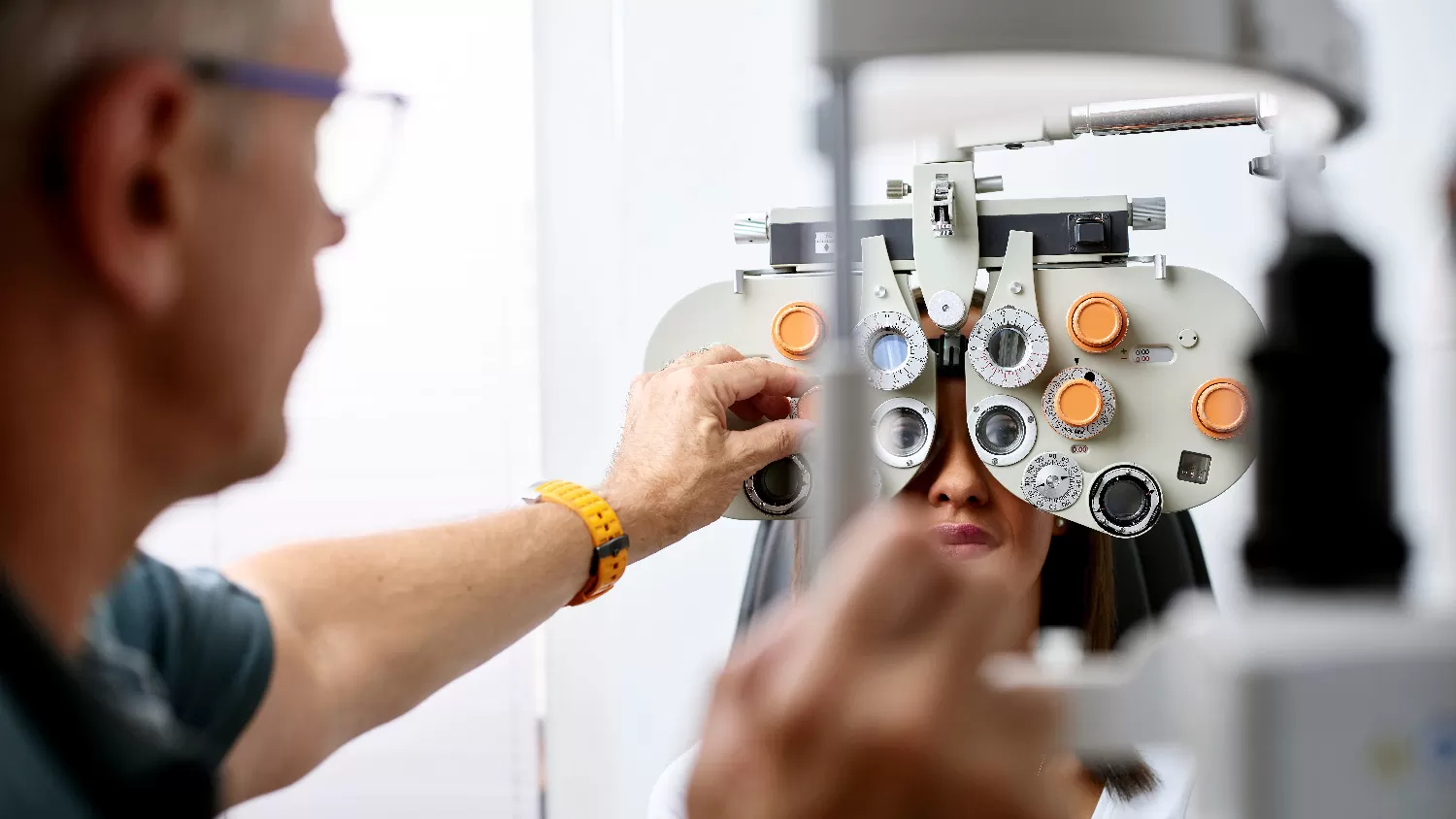Female receiving eye exam by an optometrist