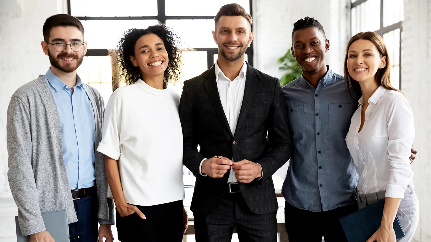 A group of people at work smiling 