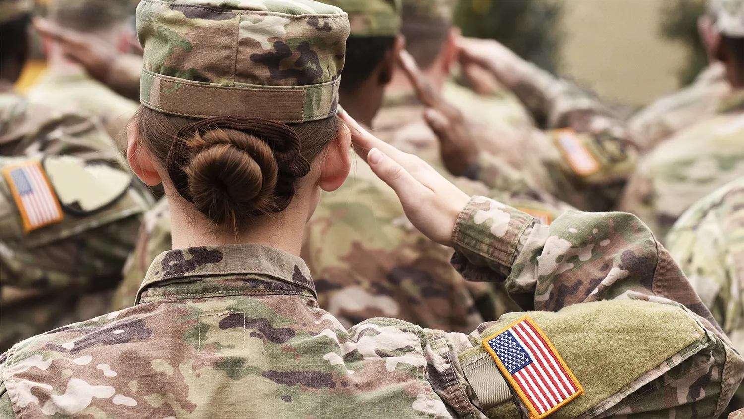 A diverse group of soldiers give the salute