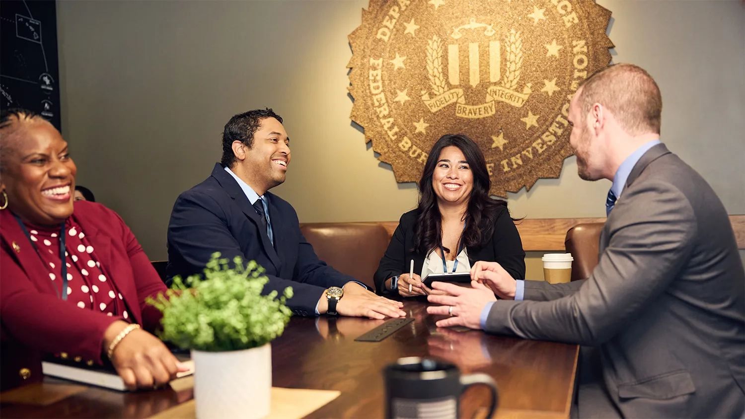 A diverse group of FBI employees at a meeting